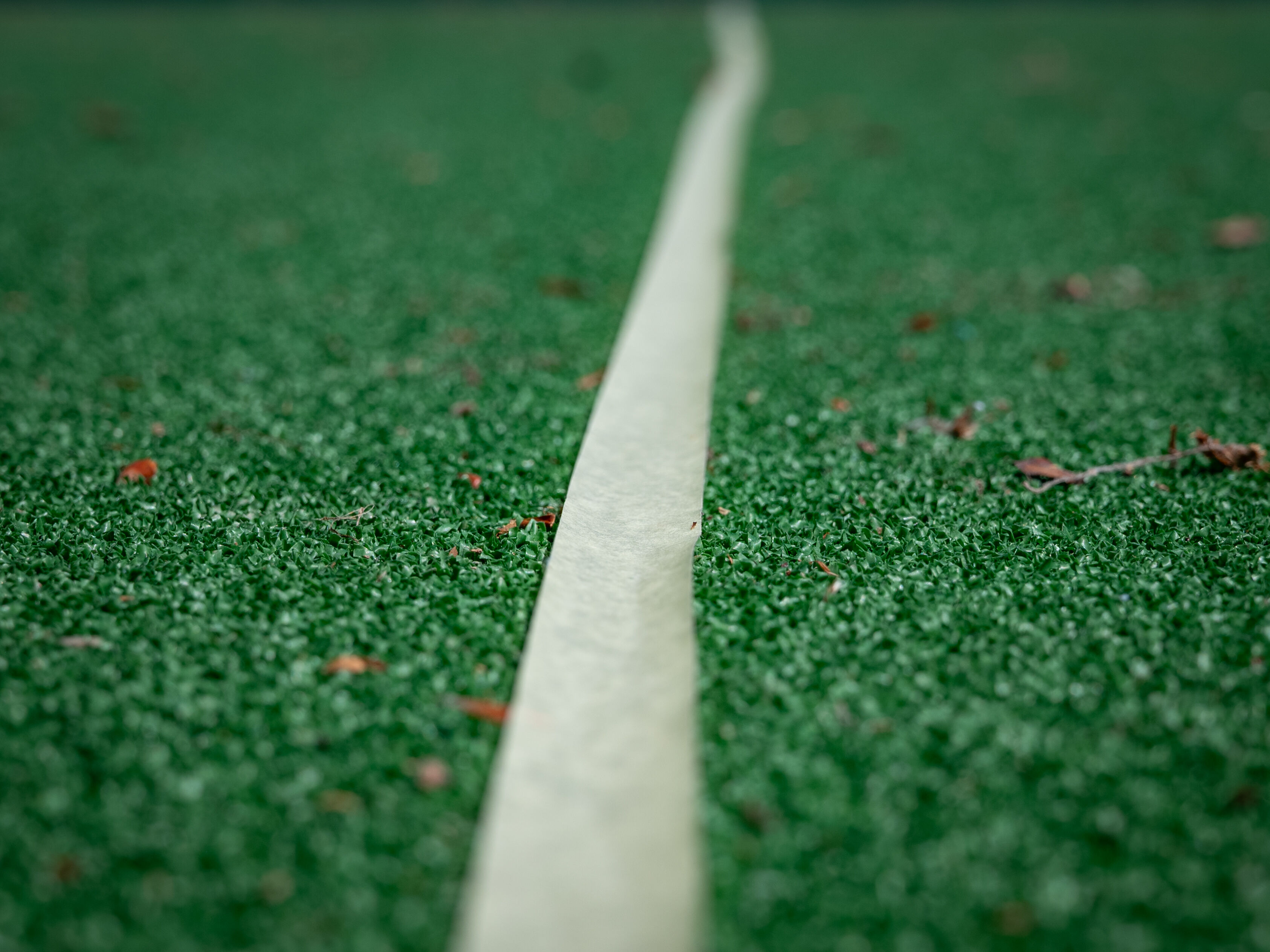 Straight crepe-tape marking on artificial lawn