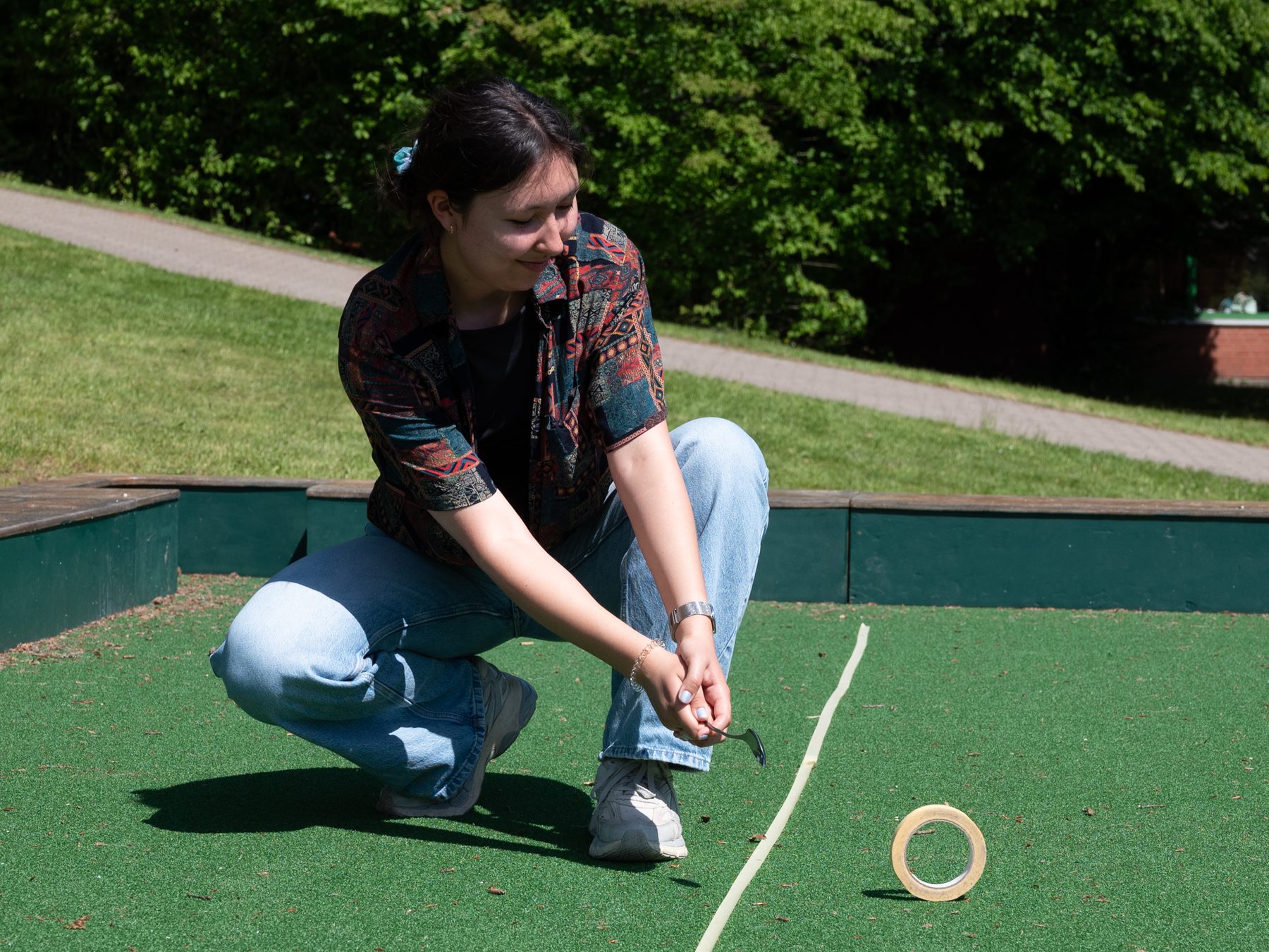 One person doing the first Spoon shot across a doorstep on artificial lawn
