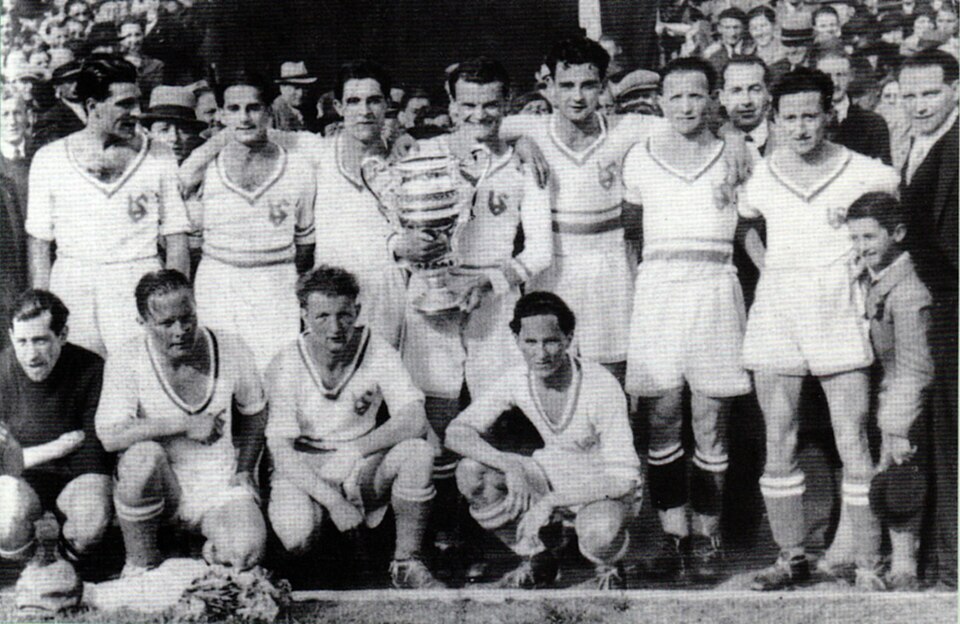 Black-and-white photograph of Crolf team holding Championships trophy